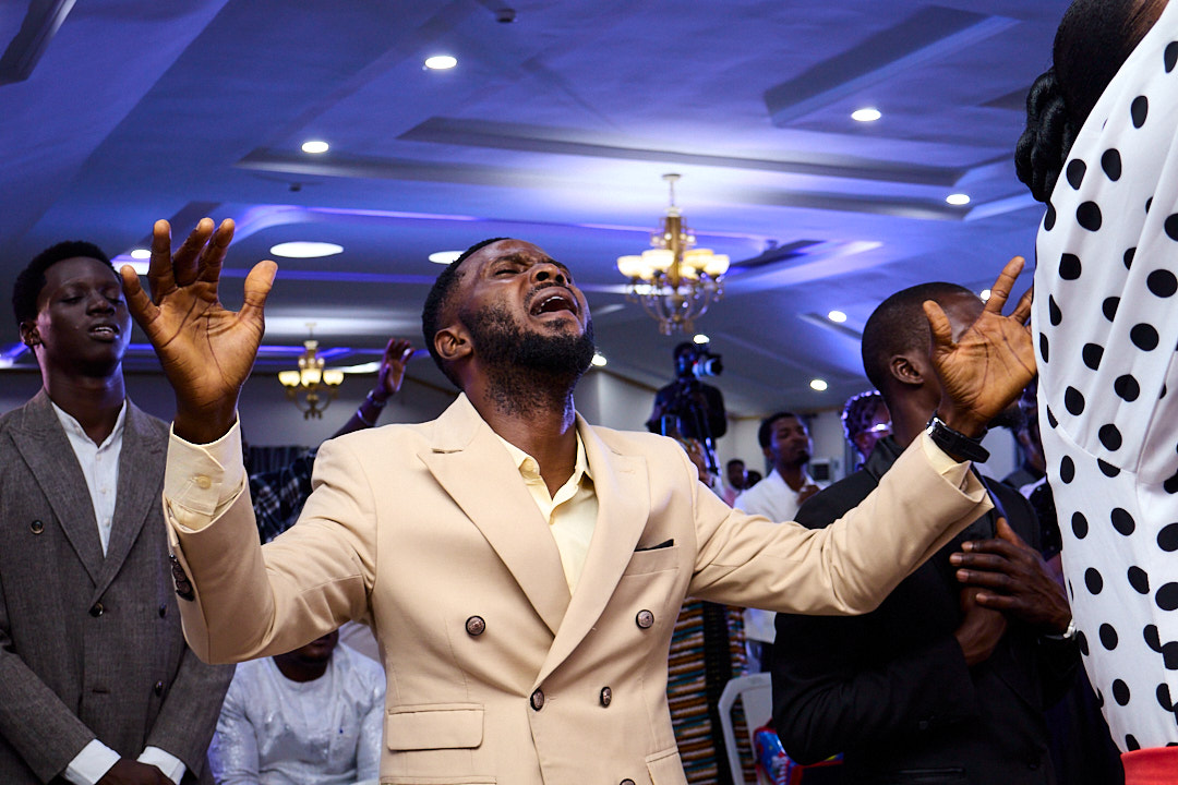 A man raising his hands in worship